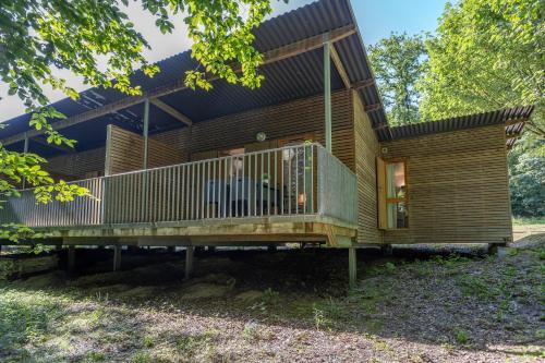 a wooden house with a large deck at Les Charmes C40B - Le Val Joly in Eppe-Sauvage