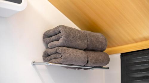a stuffed animal on a towel rack on a wall at Bobocabin Patra, Parapat in Panahatan