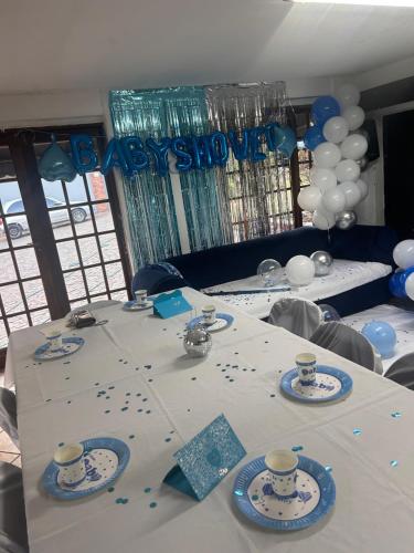 a table set up for a birthday party with balloons at Fourways executive spa and accommodation in Sandton
