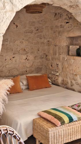 a bedroom with a large bed in a stone wall at Residenza Anima Mediterranea in Francavilla Fontana