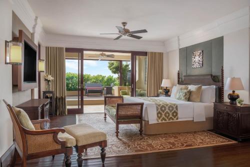 a hotel room with a bed and a balcony at The St. Regis Bali Resort in Nusa Dua
