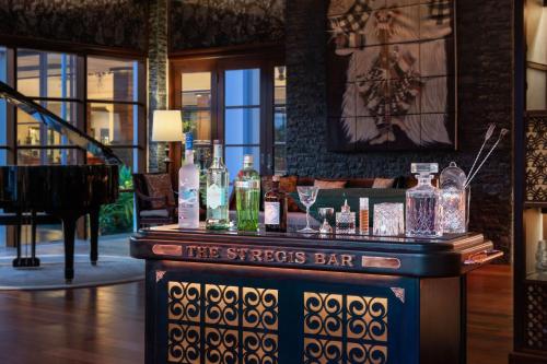 a bar in a building with bottles on it at The St. Regis Bali Resort in Nusa Dua