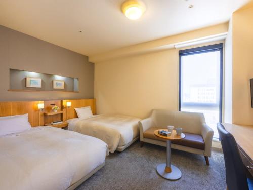 Postel nebo postele na pokoji v ubytování Urawa Washington Hotel