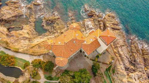 an aerial view of a house on a cliff at Suite al Castello Boccale Terrazza sul Mare in Livorno