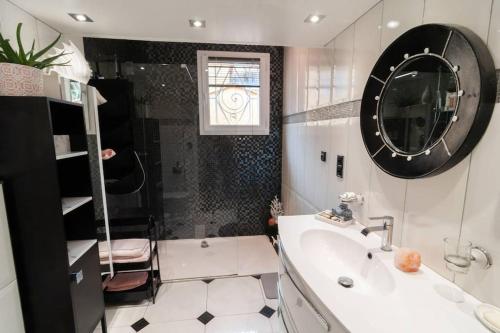 une salle de bain avec une baignoire, un lavabo et un miroir dans l'établissement FREJUS-Villa indépendante piscine et jaccuzzi, à Fréjus