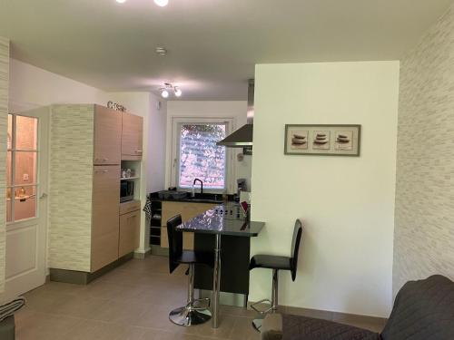 - une cuisine avec une table au milieu d'une pièce dans l'établissement Appartement proche plage et CNPE, à Gravelines