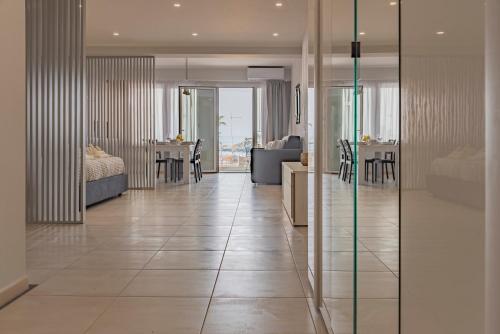 a living room with a large tile floor and a kitchen at La Finestra di Verga in Aci Castello