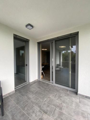 an empty patio with glass doors in a house at Modern Living in Budapest in Budapest