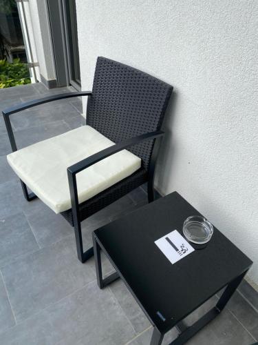 a black and white chair and a table next to a wall at Modern Living in Budapest in Budapest
