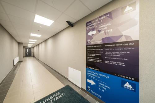 a hallway with a sign on a wall at Zaliakalnio Terasos apartamentai 2 in Kaunas