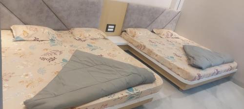 two beds sitting in a room with at Hotel Bholenath, Omkareshwar Near Gajanand Ashram in Godarpura