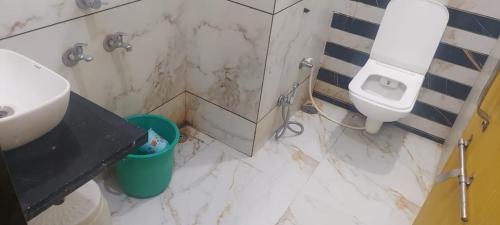 a bathroom with a sink and a toilet at Hotel Bholenath, Omkareshwar Near Gajanand Ashram in Godarpura