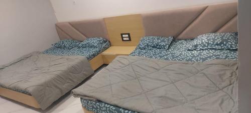 a bedroom with two beds and a head board at Hotel Bholenath, Omkareshwar Near Gajanand Ashram in Godarpura