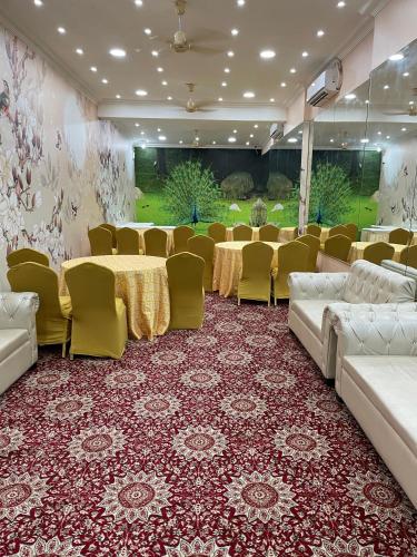 a conference room with tables and chairs in a room at Hotel Seth Murlidhar Seva Sadan-Near Prem Mandir in Vrindāvan