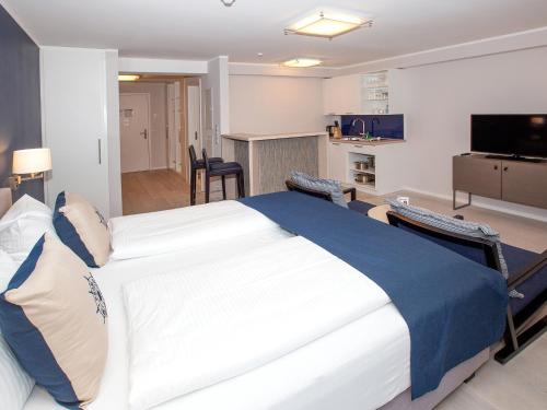 a bedroom with a large bed in a room at DORMERO Strandapartments Rügen in Binz