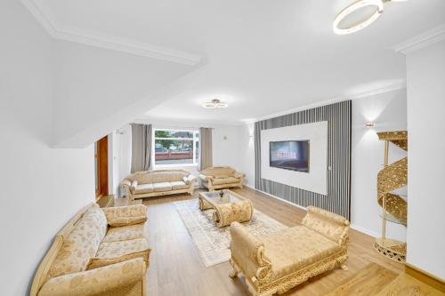 a living room with two couches and a tv at Lux 5 Bed sleeps 11, 10 mins from Wembley Stadium, Jacuzzi and Steam Shower in Harrow on the Hill