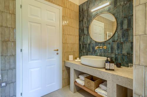 a bathroom with a sink and a mirror at Hotel Brattia, Adults Only, Heated Pool, A la Carte Breakfast, Postira, Brač Island in Postira