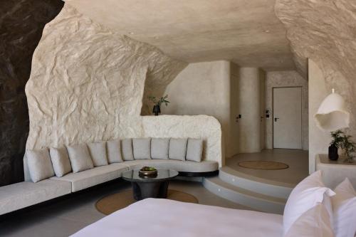 a living room with a couch and a table at One of One Hotel in Imerovigli