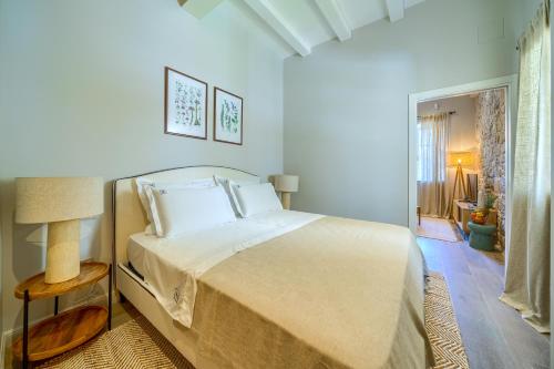 a white bedroom with a bed and a window at Hotel Brattia, Adults Only, Heated Pool, A la Carte Breakfast, Postira, Brač Island in Postira