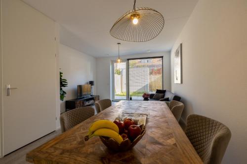a dining room table with a bowl of fruit on it at Rochuskwartier Eindhoven in Eindhoven