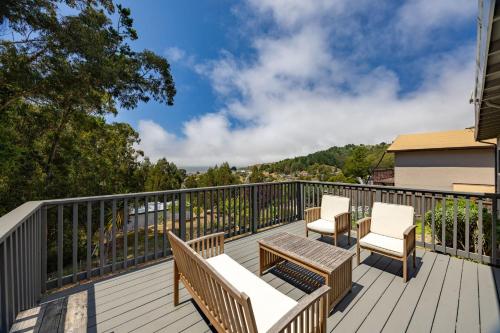 a deck with chairs and tables on a house at Entire Oceanview Coastal Retreat in Pacifica in Pacifica