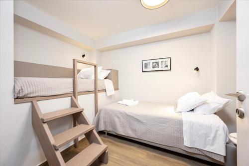 a small room with two bunk beds and a ladder at Latour Inspired by Elegance in (( Kermetés ))