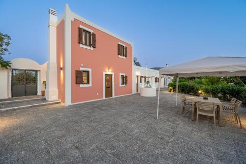 a patio with a table and chairs in front of a building at Latour Inspired by Elegance in (( Kermetés ))