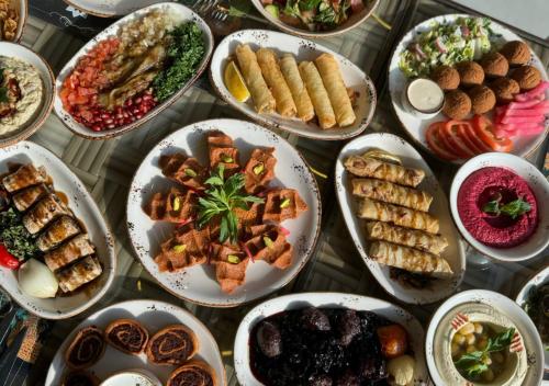 a table with many plates of food on it at Lancaster Eden Bay in Beirut