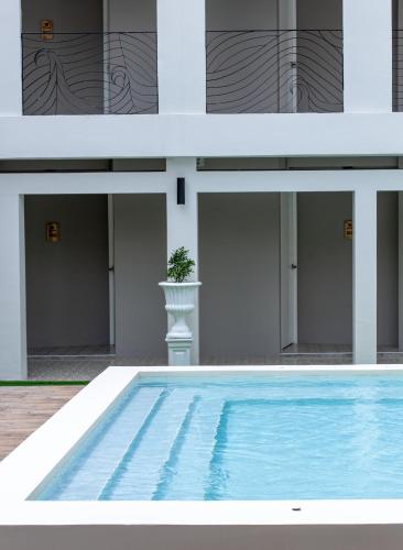 a swimming pool in front of a building at The Light House at Town Phuket in Phuket Town