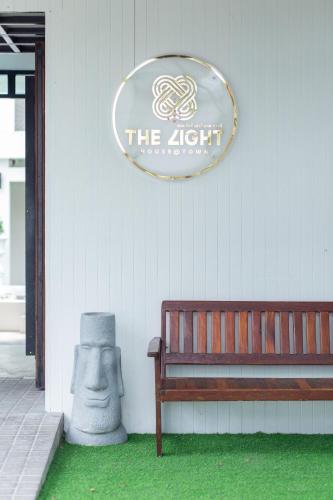 a sign on the side of a building with a bench at The Light House at Town Phuket in Phuket Town