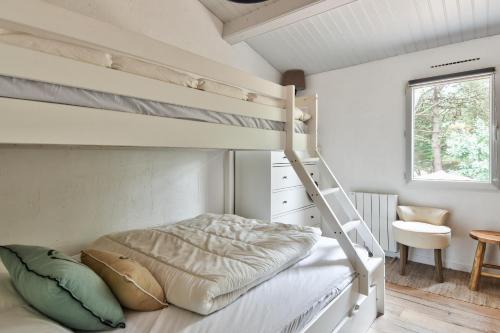 En eller flere senge i et værelse på Jolie maison pour 7 - 300 m de la plage - Dunes