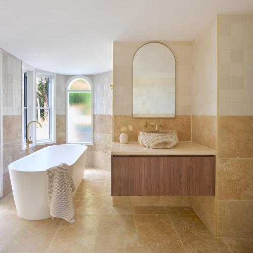 a bathroom with a tub and a sink at Karma Suites - Heart of Montville in Montville