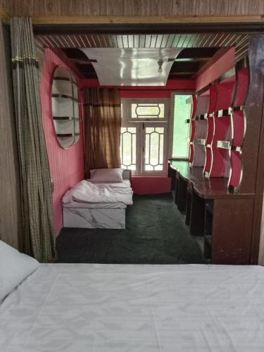 a room with two beds and a desk in a train at GOLDEN IBEX ReSOrT SKARDU in Skardu