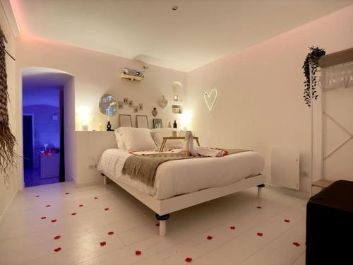 a bedroom with a bed with red flowers on the floor at Casa Love in Déville-lès-Rouen