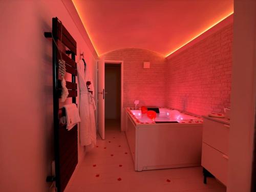 a bathroom with a tub and a red ceiling at Casa Love in Déville-lès-Rouen