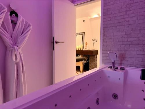 a bathroom with a large tub with a mirror at Casa Love in Déville-lès-Rouen