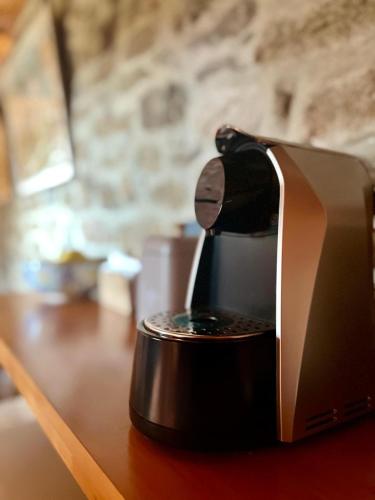 a coffee maker sitting on top of a table at Aveleira EcoCasa in Melgaço