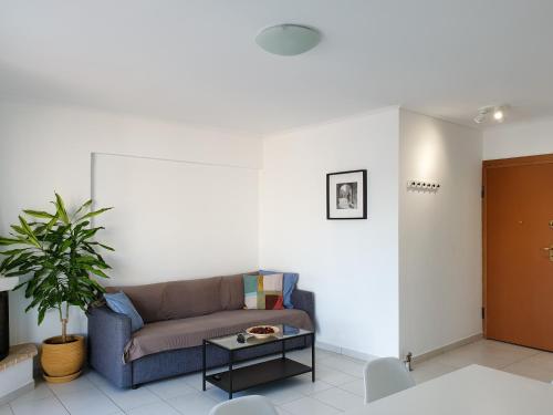 a living room with a couch and a table at KYMA Apartments - Athens Acropolis 14 in Athens