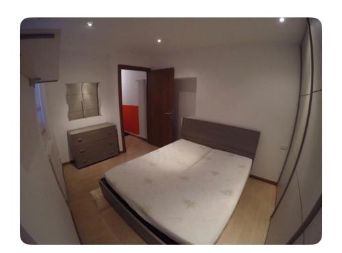 a small bedroom with a bed and a dresser at Appartamento in Centro Storico - Boutique in Clusone