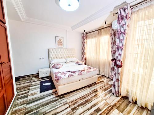 a bedroom with a bed in a room at BELMANN BONAPRISO in Douala
