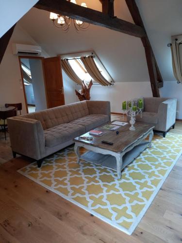 a living room with a couch and a coffee table at Domaine De Barive in Sainte-Preuve