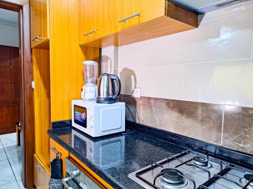 a kitchen with a stove and a blender on a counter at BELMANN BONAPRISO in Douala