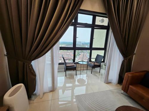a room with a large window with a table and chairs at 3BR The Luxurie at Paradigm Mall Residences in Johor Bahru