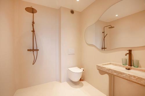 a bathroom with a toilet and a sink at Tinah Saint-Tropez in Saint-Tropez