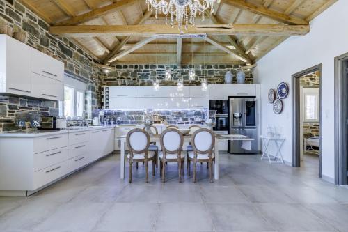 a large kitchen with a table and chairs at Villa Zoe in Panormos Skopelos