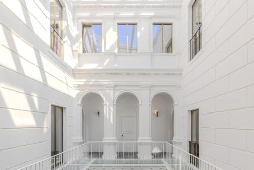 a hallway of a building with white walls and windows at Dome Hotel in Marsala