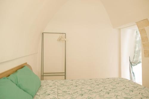 a bedroom with a bed and a mirror on the wall at Sud Est 13 in Putignano