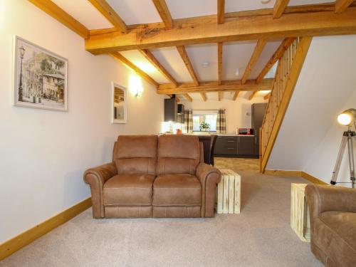a leather chair in a living room with wooden ceilings at Bangor in Wrexham