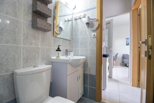 a bathroom with a toilet and a sink at Comfy Beachside Flat with Seaview 2 in Amoudara Herakliou