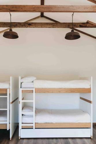 two bunk beds in a room with two lights at Seymour House in Moss Vale